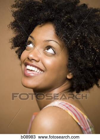 Stock Image - Close-up of a young woman smiling. Fotosearch