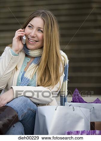Stock Photo - Close-up of a young woman talking on a mobile phone. Fotosearch