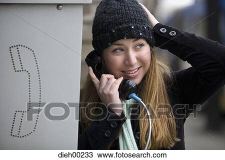 Close-up of a young woman talking on the telephone View Large Photo Image Stock Image - Close-up of a young woman talking on the telephone. Fotosearch