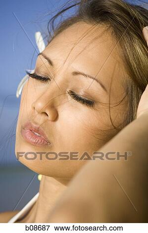 Close-up of a young woman with her eyes closed View Large Photo Image Stock Photo - Close-up of a young woman with her eyes closed. Fotosearch