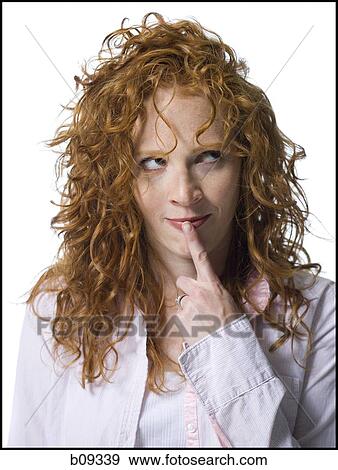 Close-up of a young woman with her finger on her lips View Large Photo Image Stock Photo - Close-up of a young woman with her finger on her lips. Fotosearch