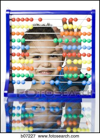 Close-up of child with counting beads View Large Photo Image Stock Photo - Close-up of child with counting beads. Fotosearch