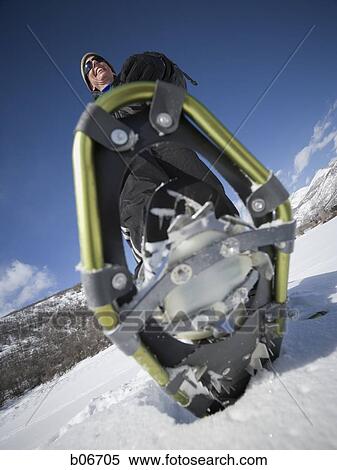 Close-up of man walking with snow shoes View Large Photo Image Stock Photography - Close-up of man walking with snow shoes. Fotosearch
