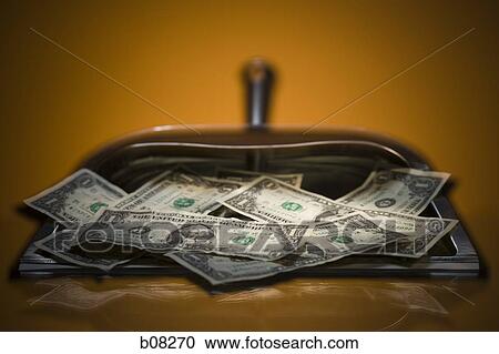 Close-up of money in a dustpan View Large Photo Image Stock Image - Close-up of money in a dustpan. Fotosearch