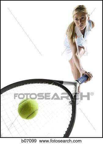 Close-up of tennis player hitting ball View Large Photo Image Stock Photo - Close-up of tennis player hitting ball. Fotosearch
