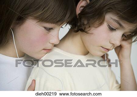 Stock Photo - Close-up of two girls listening to music. Fotosearch