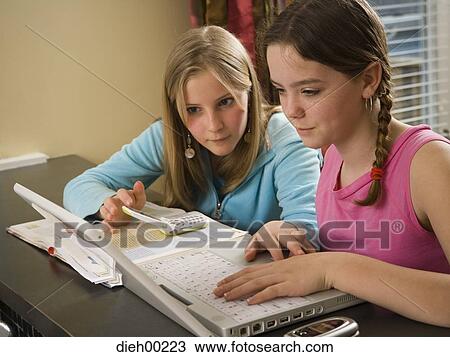 Stock Image - Close-up of two girls working on a laptop. Fotosearch