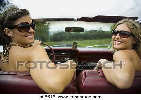 Close-up of two young women wearing sunglasses driving a car View Large Photo Image Stock Photograph - Close-up of two young women wearing sunglasses driving a car. Fotosearch