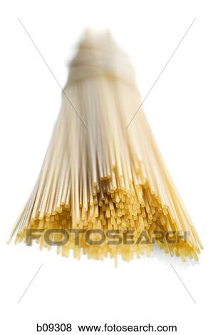 Close-up of uncooked spaghetti against a white background View Large Photo Image Stock Photo - Close-up of uncooked spaghetti against a white background. Fotosearch