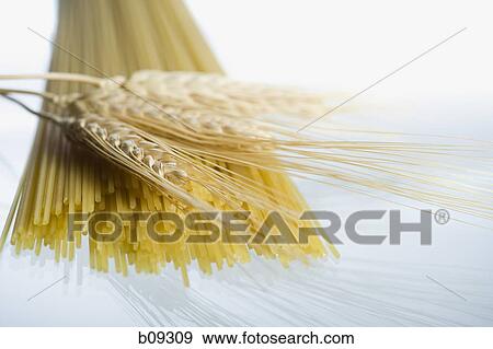 Close-up of wheat stalks and uncooked spaghetti View Large Photo Image Stock Photo - Close-up of wheat stalks and uncooked spaghetti. Fotosearch