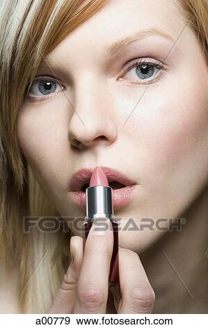 Close-up of woman applying make up View Large Photo Image Stock Photo - Close-up of woman applying make up. Fotosearch