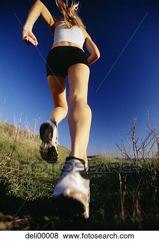 Close-up of woman running View Large Photo Image Stock Photo - Close-up of woman running. Fotosearch