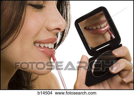 Closeup of woman applying lipstick with compact mirror View Large Photo Image Picture - Closeup of woman applying lipstick with compact mirror. Fotosearch