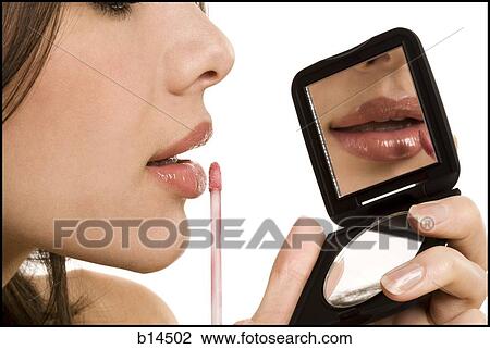Closeup of woman applying lipstick with compact mirror View Large Photo Image Stock Image - Closeup of woman applying lipstick with compact mirror. Fotosearch