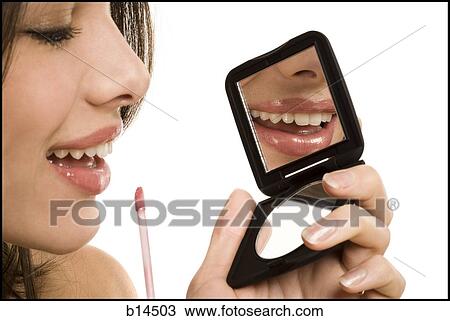 Closeup of woman applying lipstick with compact mirror View Large Photo Image Stock Image - Closeup of woman applying lipstick with compact mirror. Fotosearch