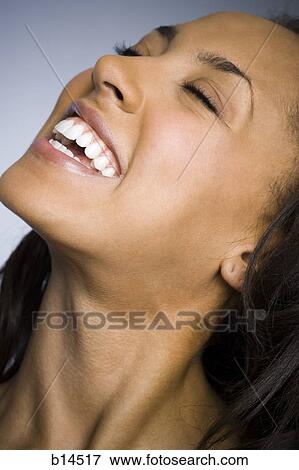 Closeup of woman smiling with eyes closed View Large Photo Image Stock Photo - Closeup of woman smiling with eyes closed. Fotosearch