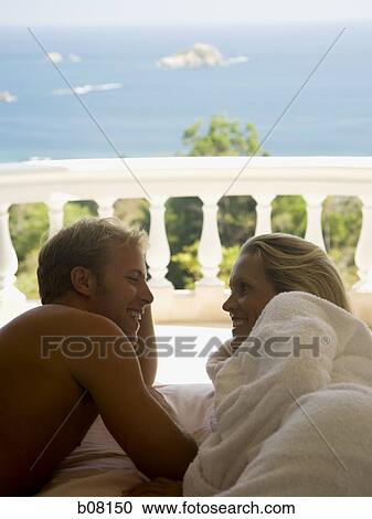 Couple by railing overlooking ocean View Large Photo Image Stock Image - Couple by railing overlooking ocean. Fotosearch