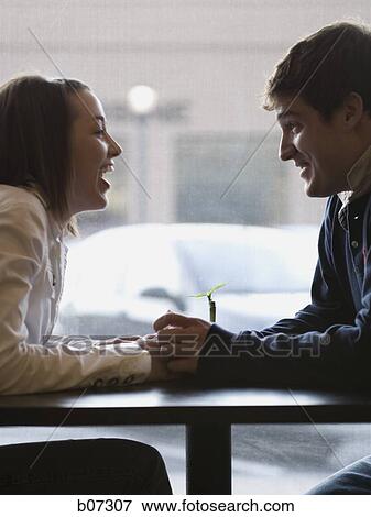Couple holding hands over table View Large Photo Image Stock Photo - Couple holding hands over table. Fotosearch