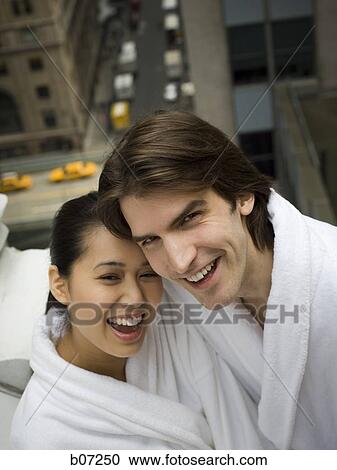 Couple in bathrobes on a balcony View Large Photo Image Stock Image - Couple in bathrobes on a balcony. Fotosearch