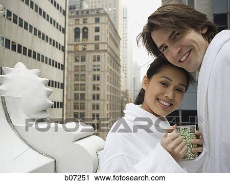 Couple in bathrobes on a balcony View Large Photo Image Stock Image - Couple in bathrobes on a balcony. Fotosearch