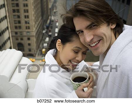 Couple in bathrobes on a balcony View Large Photo Image Stock Image - Couple in bathrobes on a balcony. Fotosearch