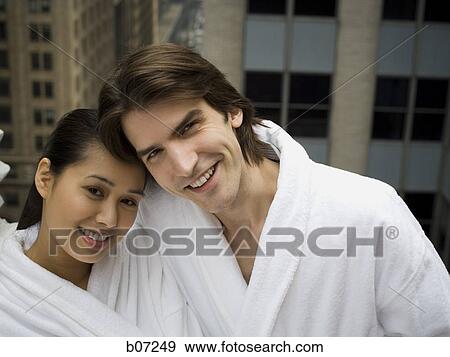 Couple in bathrobes on a balcony View Large Photo Image Stock Photo - Couple in bathrobes on a balcony. Fotosearch