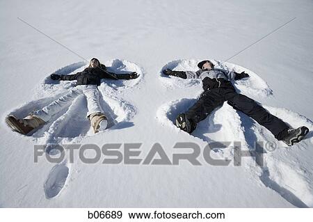 Couple making snow angels View Large Photo Image Stock Photo - Couple making snow angels. Fotosearch