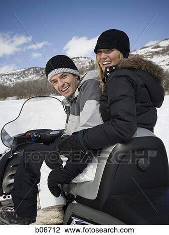 Couple on snow mobile View Large Photo Image Stock Image - Couple on snow mobile. Fotosearch