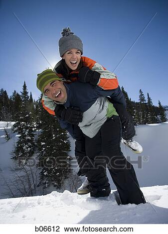 Couple playing in the snow View Large Photo Image Stock Image - Couple playing in the snow. Fotosearch