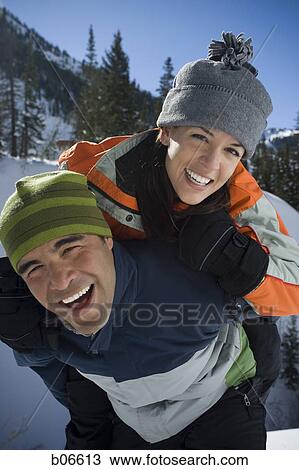 Couple playing in the snow View Large Photo Image Stock Image - Couple playing in the snow. Fotosearch