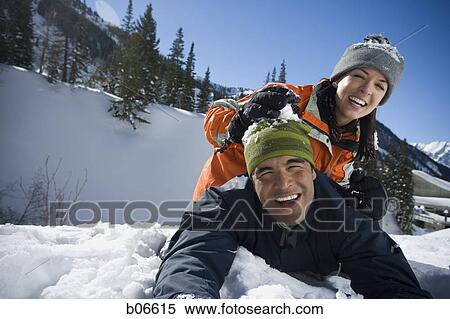 Stock Photography - Couple playing in the snow. Fotosearch
