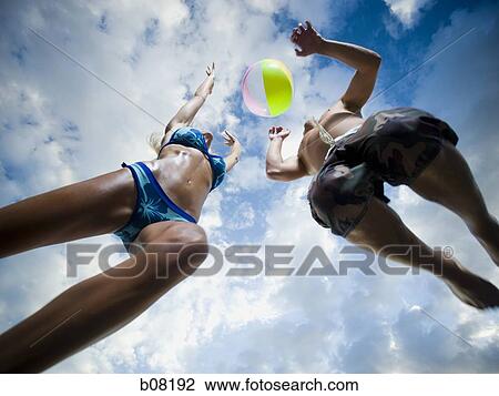 Couple playing with beachball on beach View Large Photo Image Stock Image - Couple playing with beachball on beach. Fotosearch
