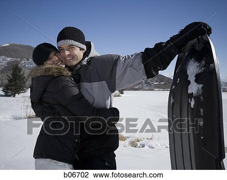 Couple posing with toboggan View Large Photo Image Stock Image - Couple posing with toboggan. Fotosearch