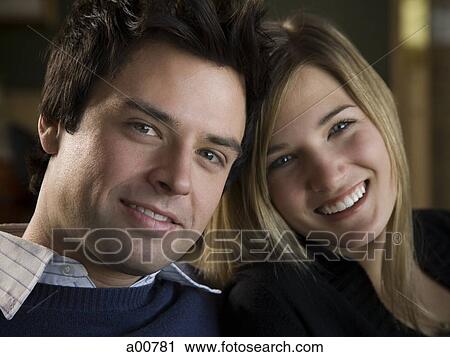 Couple sitting close and smiling View Large Photo Image Stock Image - Couple sitting close and smiling. Fotosearch