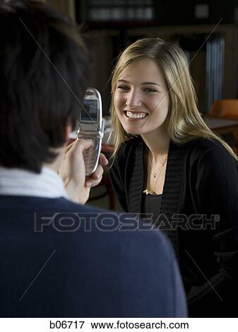 Couple taking photo with camera phone View Large Photo Image Stock Photo - Couple taking photo with camera phone. Fotosearch
