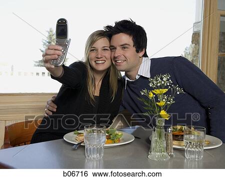 Couple taking photo with camera phone View Large Photo Image Stock Photograph - Couple taking photo with camera phone. Fotosearch