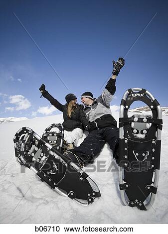 Couple with snow shoes View Large Photo Image Stock Image - Couple with snow shoes. Fotosearch