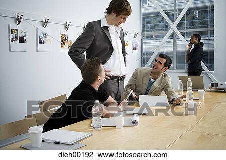 Stock Image - Creative agency staff consulting on project. Fotosearch