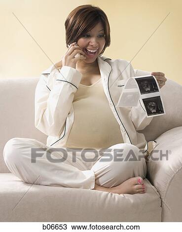 Expecting mother talking on cellphone View Large Photo Image Stock Image - Expecting mother talking on cellphone. Fotosearch