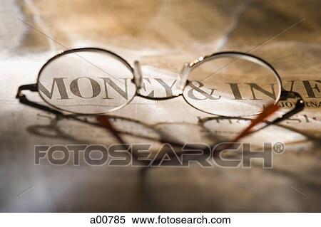 Eyeglasses resting on financial newspaper View Large Photo Image Stock Photography - Eyeglasses resting on financial newspaper. Fotosearch