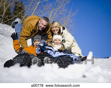 Stock Photo - Family having fun with inner tube. Fotosearch
