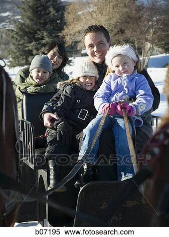 Family riding in horse drawn sleigh View Large Photo Image Stock Photography - Family riding in horse drawn sleigh. Fotosearch