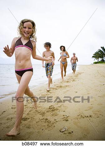 Family running on the beach View Large Photo Image Stock Photo - Family running on the beach. Fotosearch