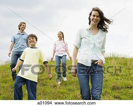 Family walking in a field View Large Photo Image Picture - Family walking in a field. Fotosearch