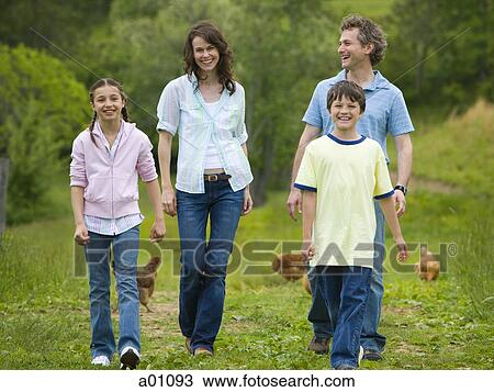 Family walking in a field View Large Photo Image Stock Image - Family walking in a field. Fotosearch