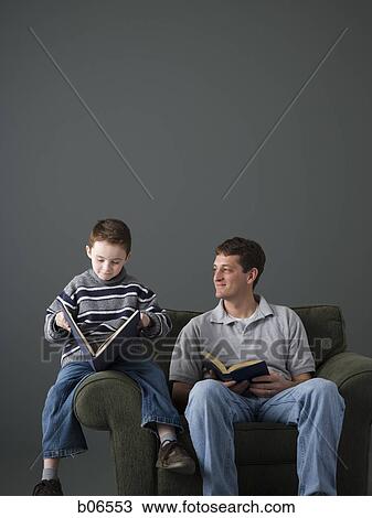 Father and son reading on armchair View Large Photo Image Stock Image - Father and son reading on armchair. Fotosearch