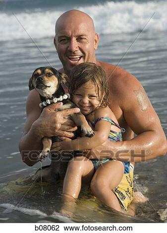 Father playing with young daughter at beach View Large Photo Image Stock Image - Father playing with young daughter at beach. Fotosearch