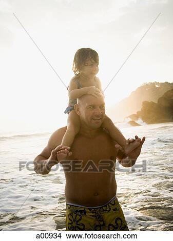 Father playing with young daughter on beach View Large Photo Image Picture - Father playing with young daughter on beach. Fotosearch