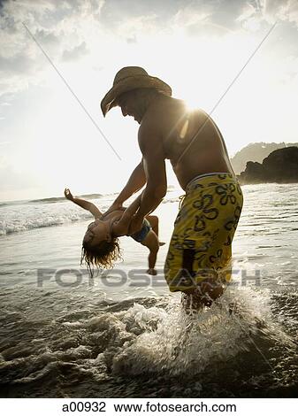 Father playing with young daughter on beach View Large Photo Image Stock Image - Father playing with young daughter on beach. Fotosearch