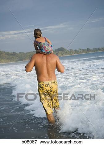 Father playing with young daughter on beach View Large Photo Image Stock Photo - Father playing with young daughter on beach. Fotosearch